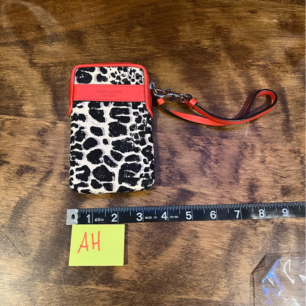 Authentic vintage orange leather and animal print Coach wristlet